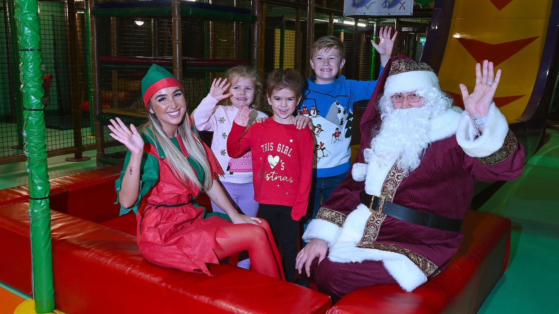 Picture of Children in soft play area beside Santa Claus and elf