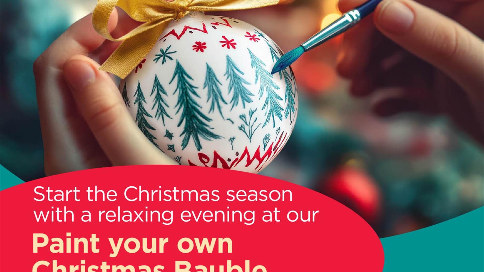 Image is of someone painting a Christmas Bauble