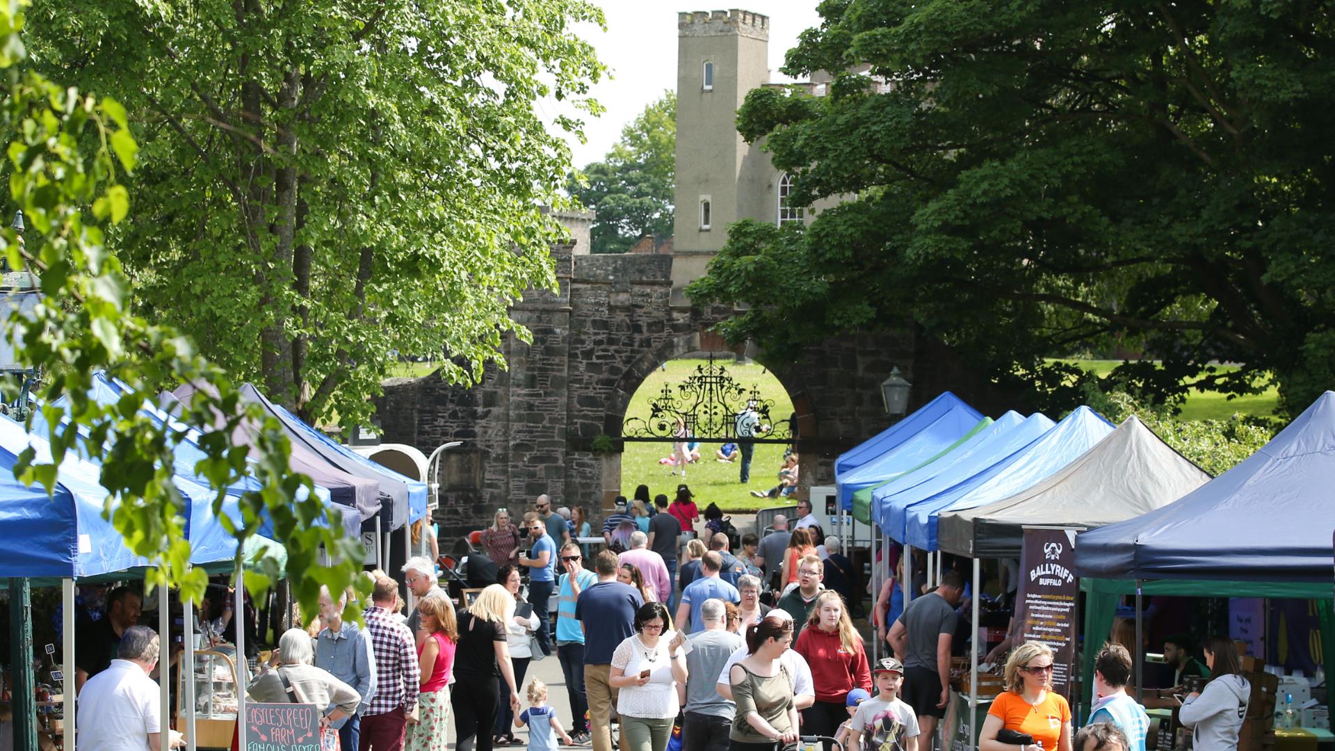 Stall holders and customers on the Dark Walk leading to the fort
