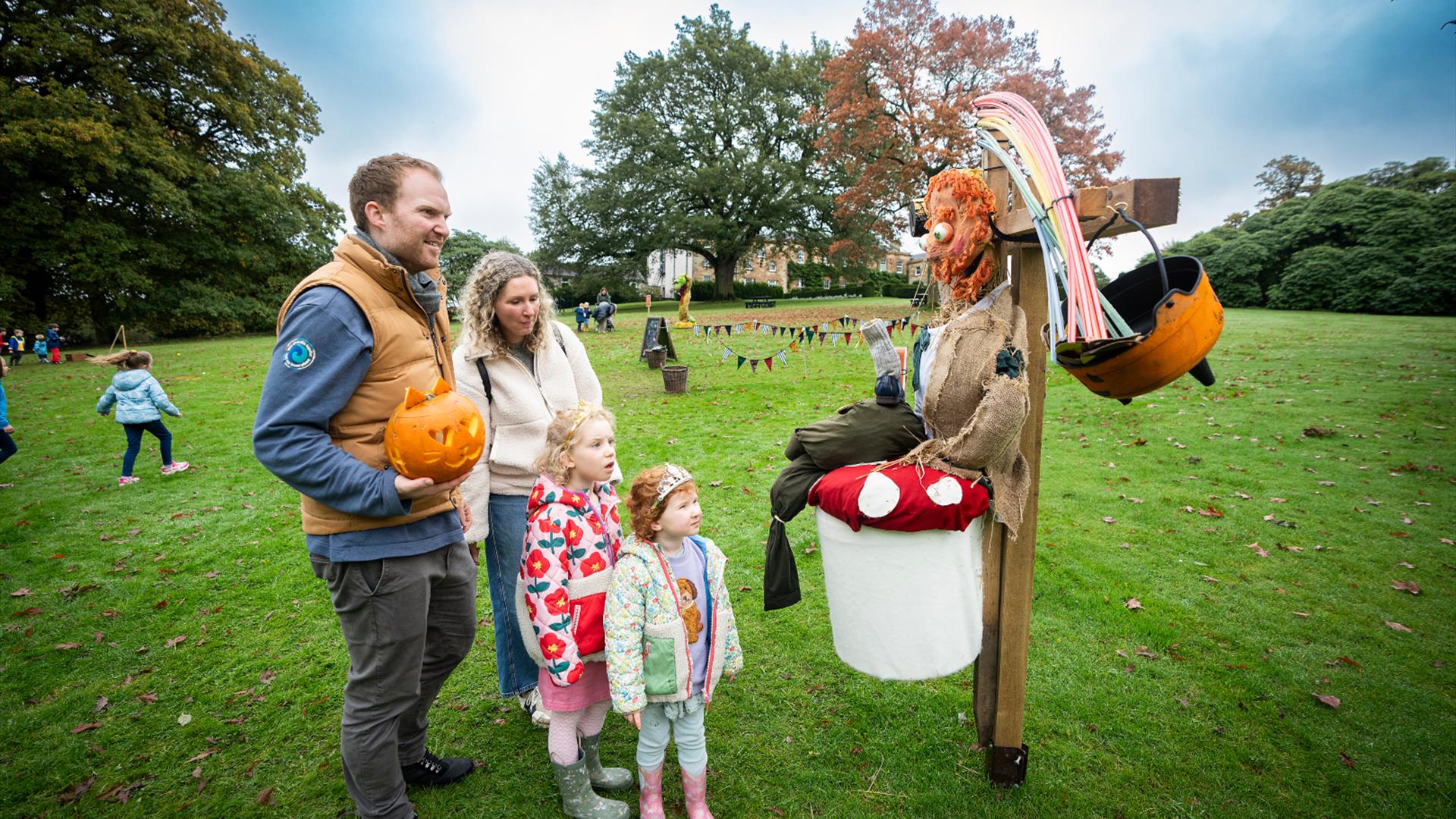 Family looking at scarecrow in grounds of Hillsborough Castle & Gardens