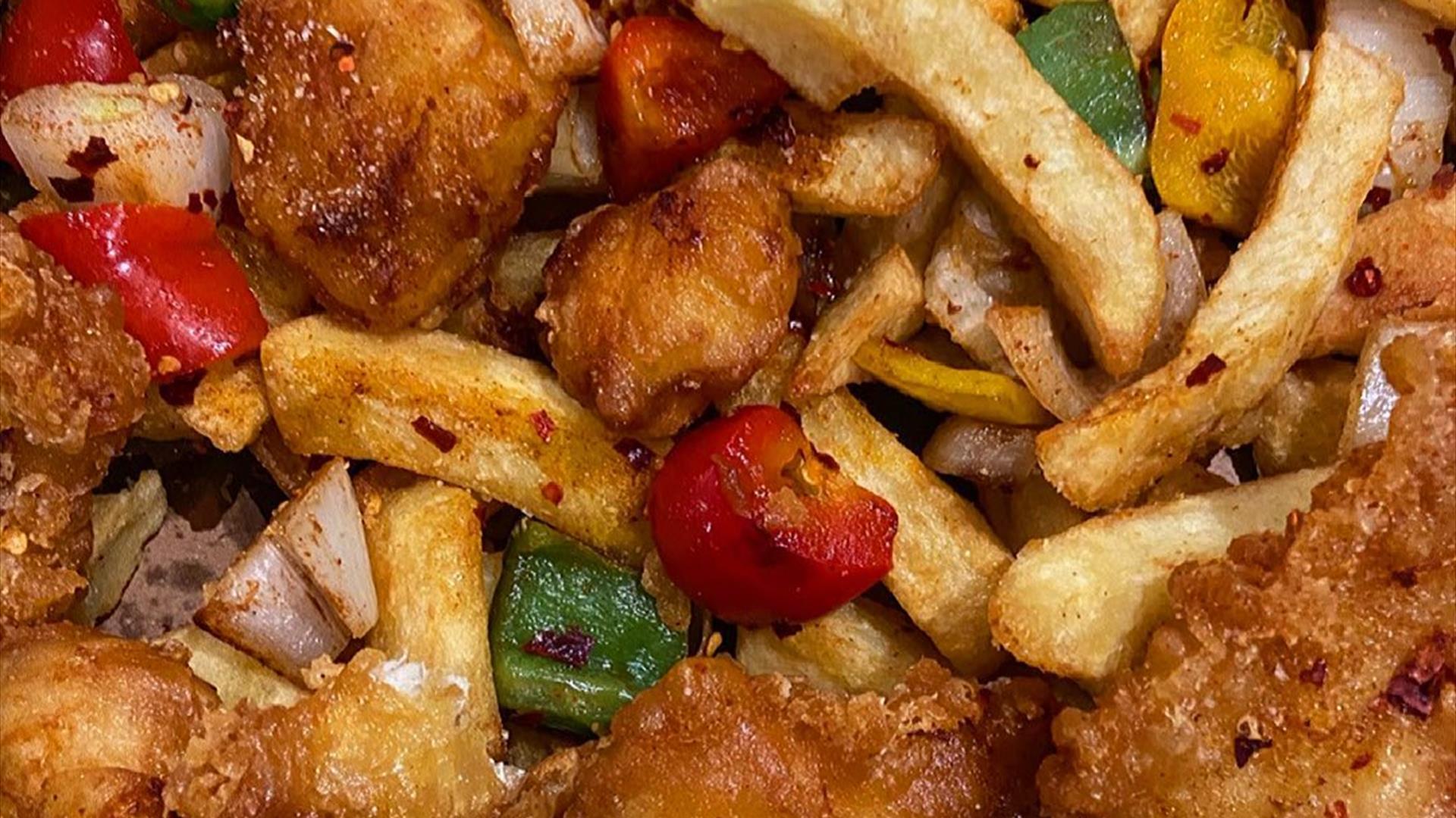 A meal including chicken and peppers with chips from the Chip Hawker