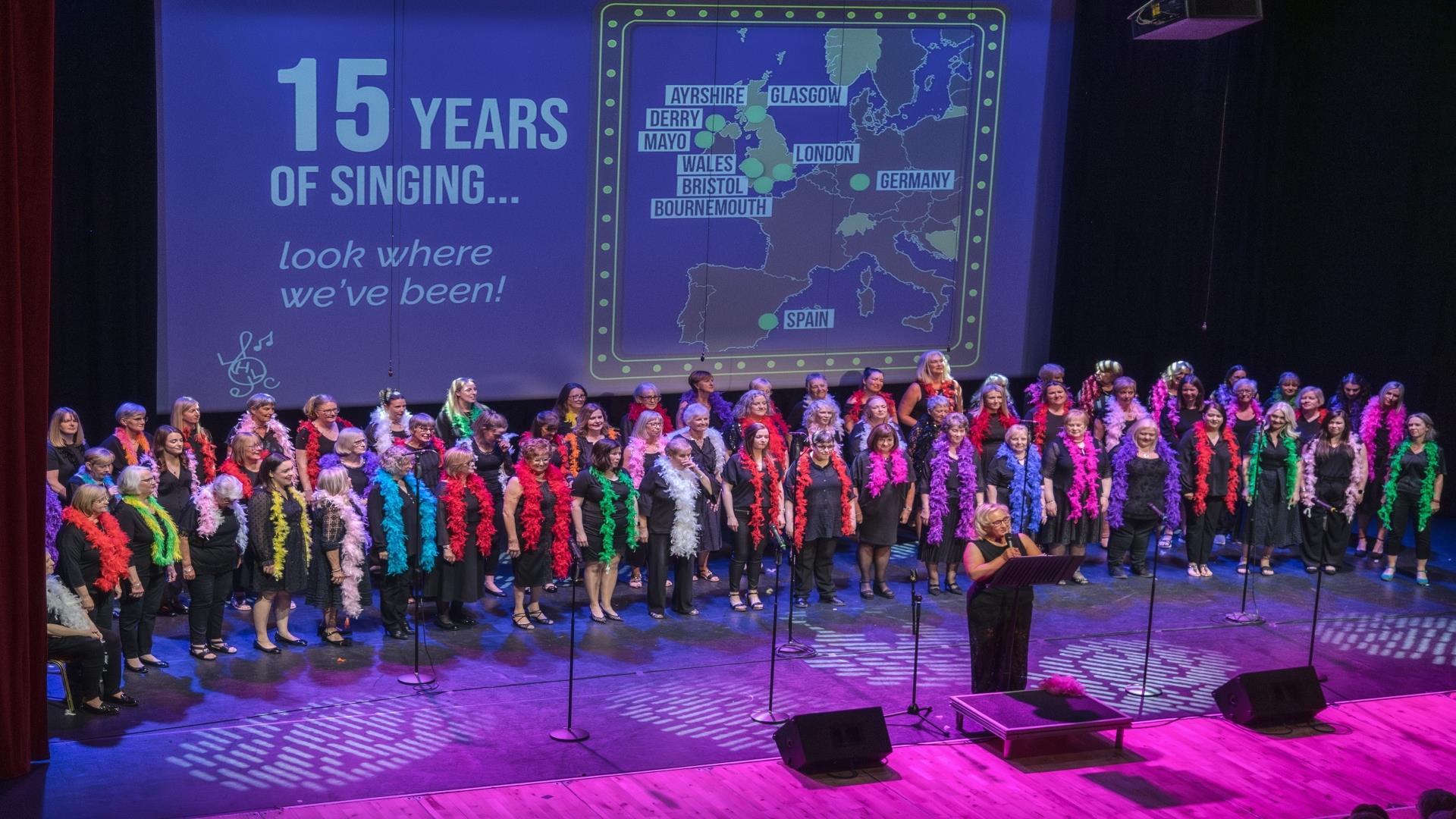 Image shows the Lisburn Harmony Choir members performing on stage.