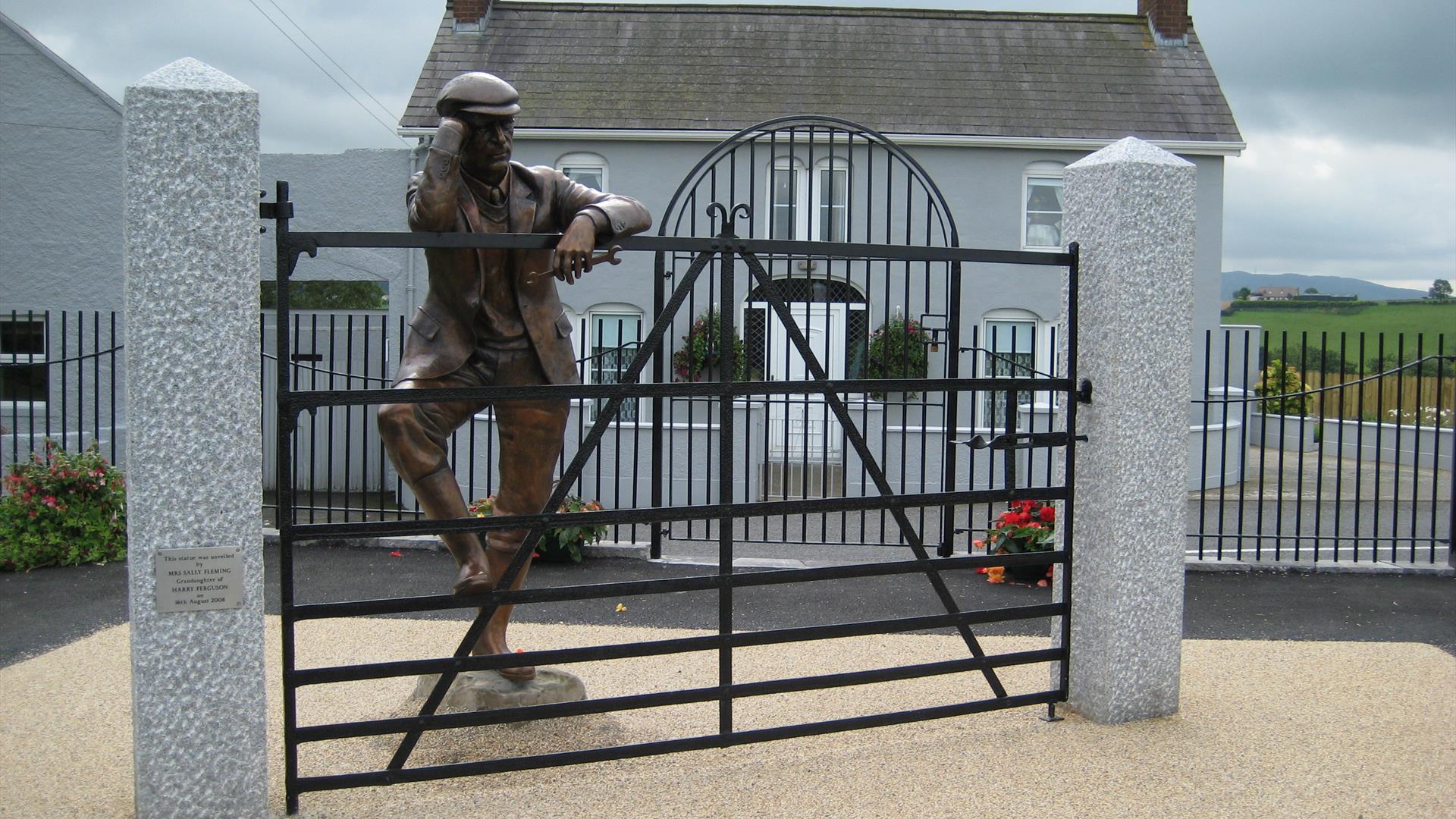 Sculpture of Harry Ferguson looking over his gate