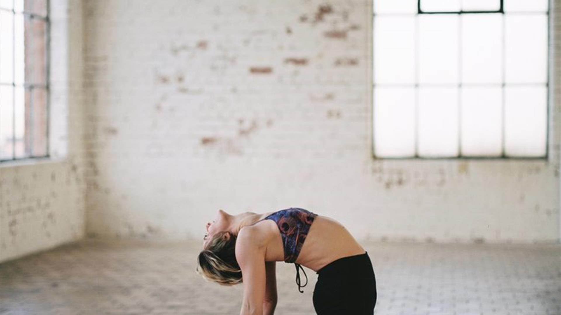 Lady doing yoga on pink mat
