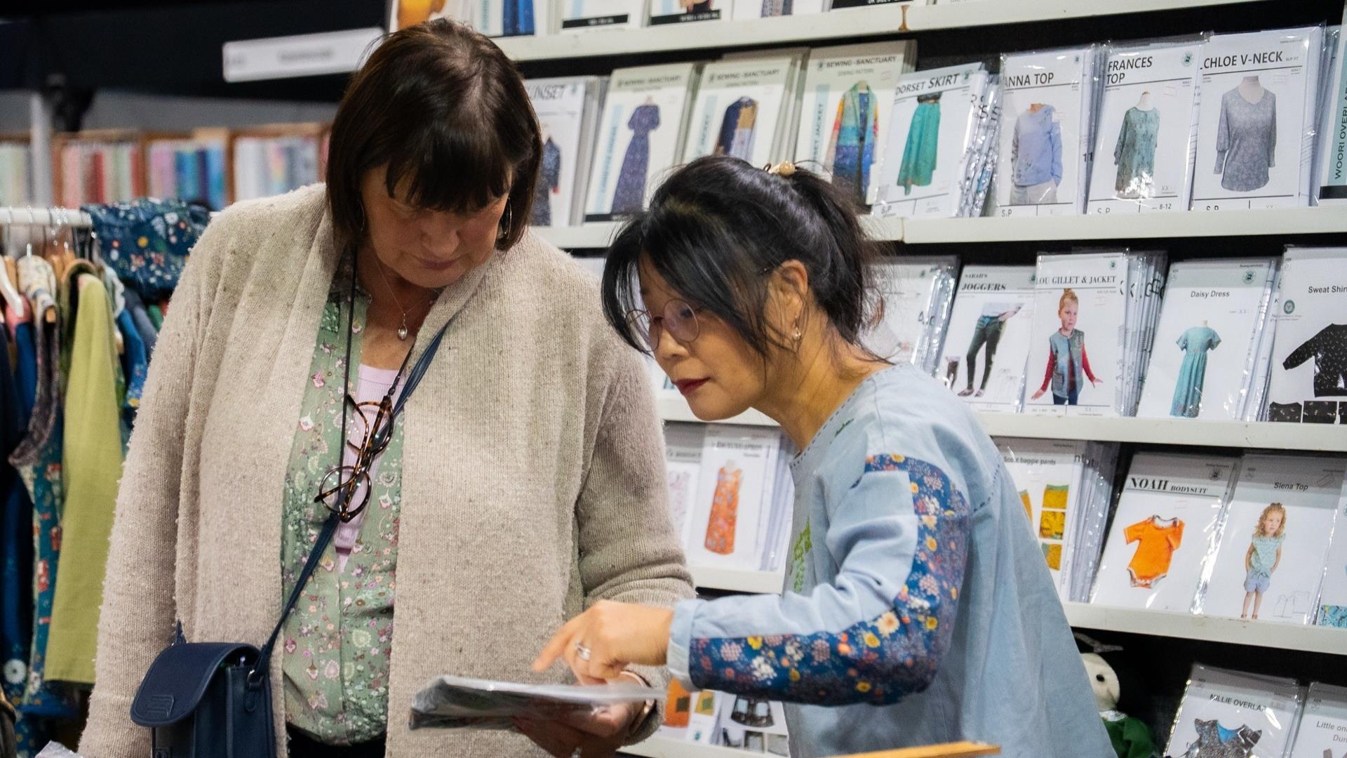 Two attendees browsing the exhibition.