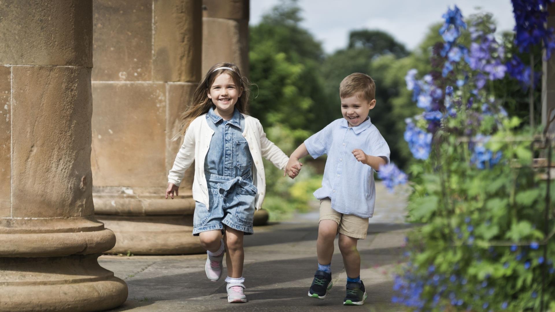 Image shows two children playing in Hillsborough Castle Gardens.