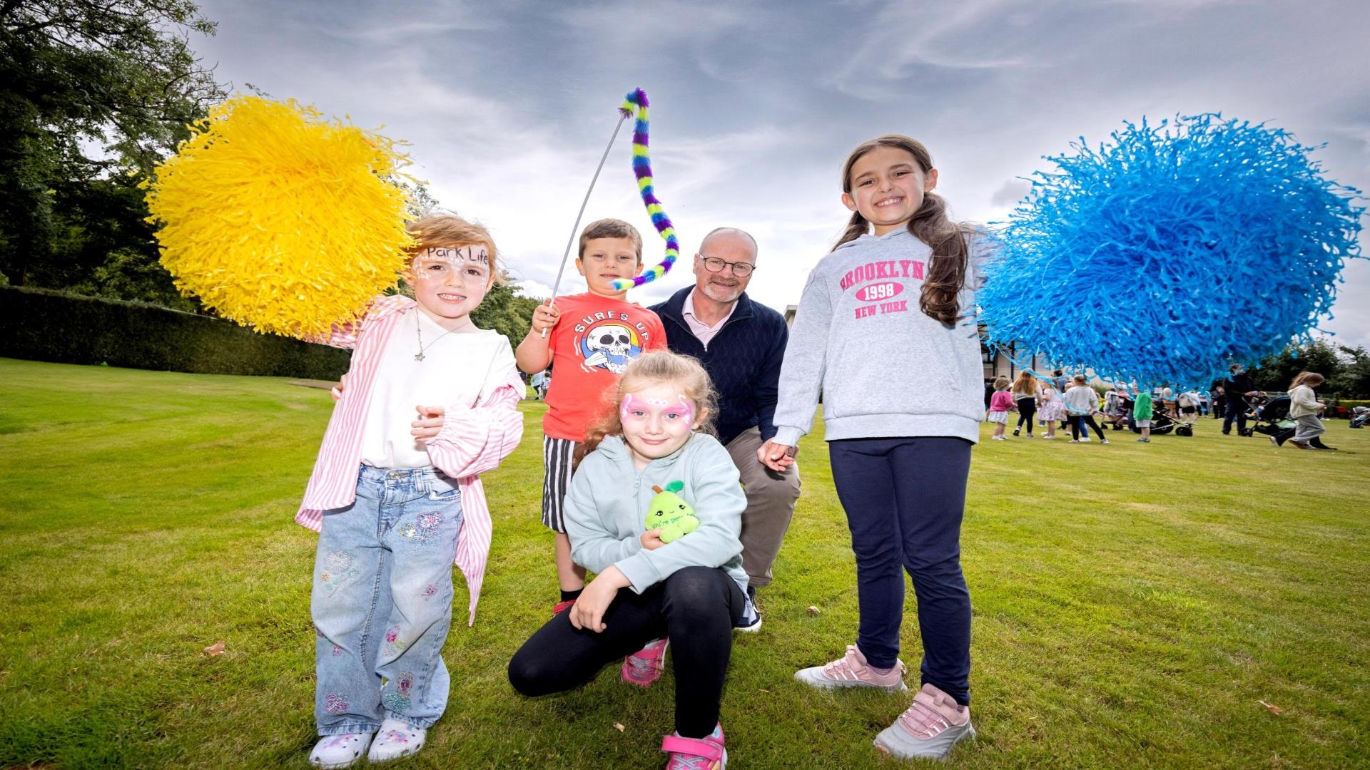 Councillor Tim Mitchell, Chair of our Communities and Wellbeing Committee pictured with local children enjoying last year's Park Life events.