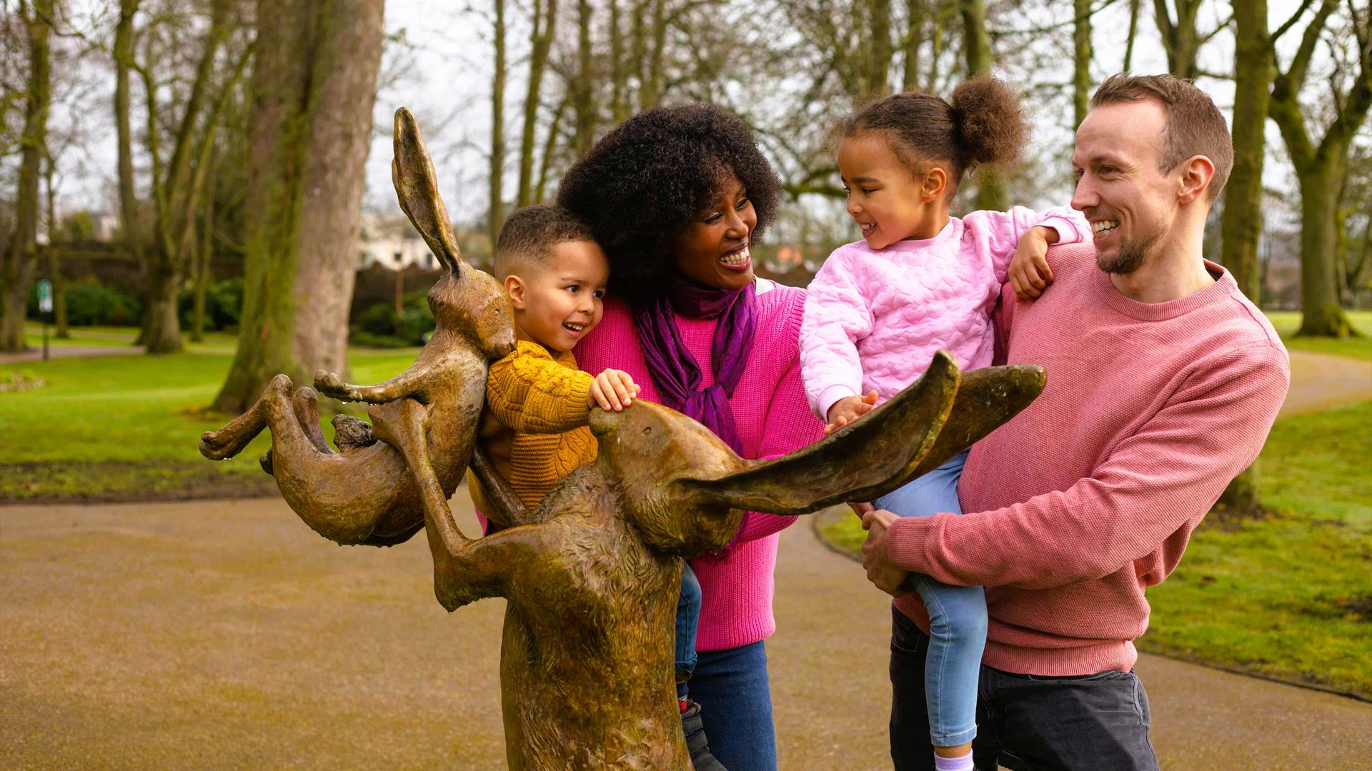 Family at Guess How Much I Love You sculpture in Castle Gardens, Lisburn