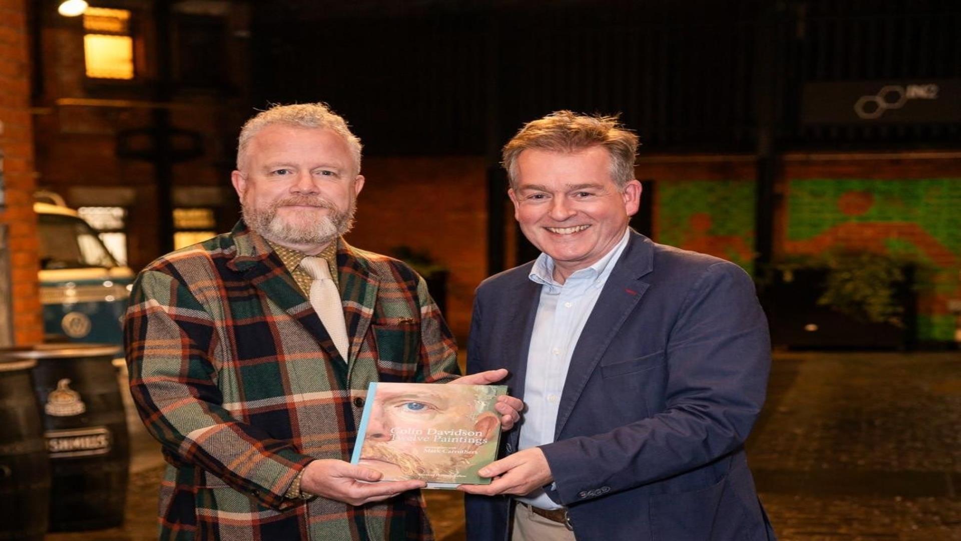 Image shows Colin Davidson and Mark Carruthers holding book at their launch.