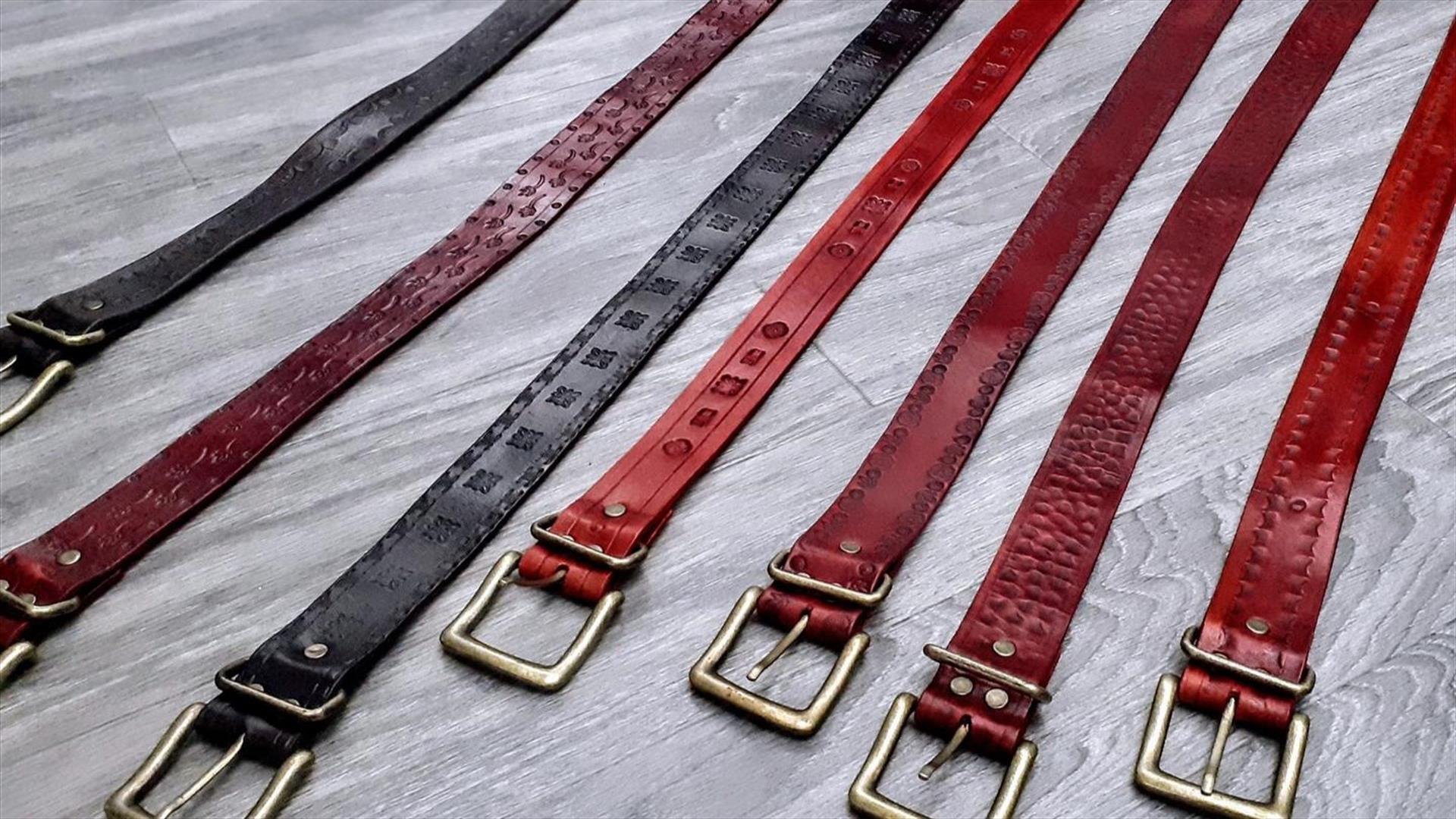 A selection of leather belts with buckles.