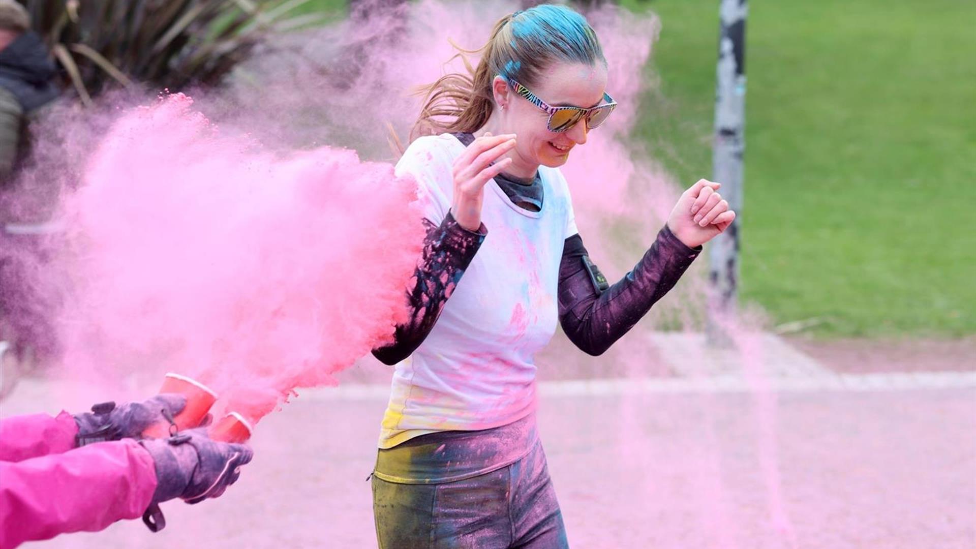 Image is of female taking part in the Mayor's Colour Run in Dundonald