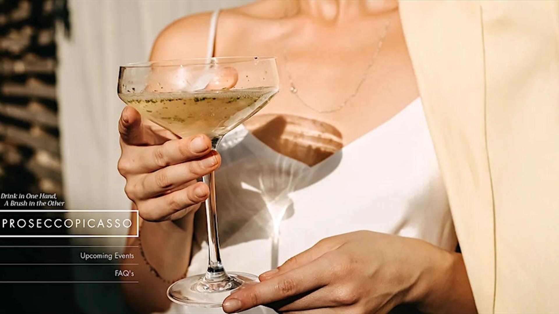 Image is of a lady holding a glass of Prosecco