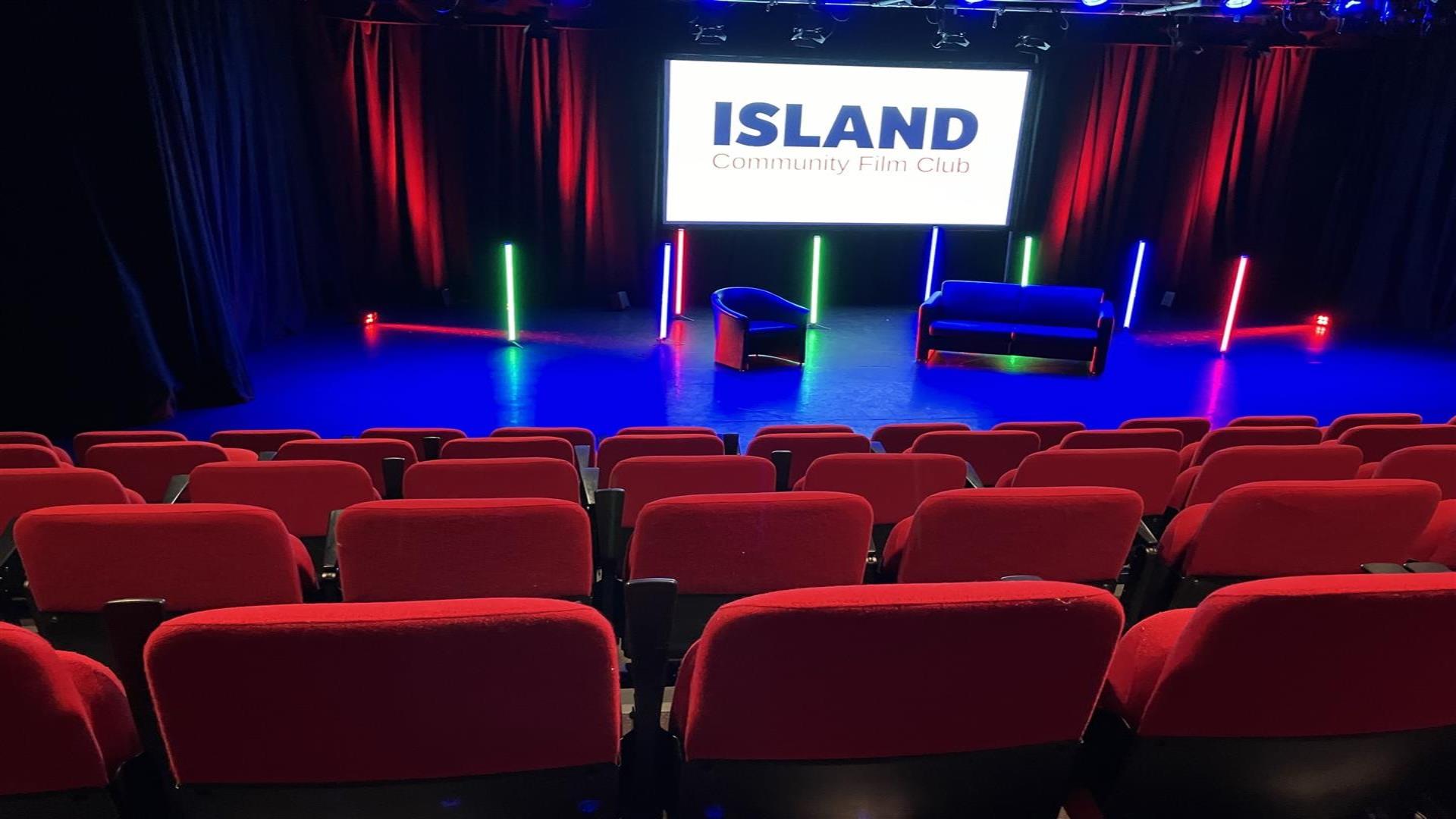 Image is of cinema seats in a small theatre