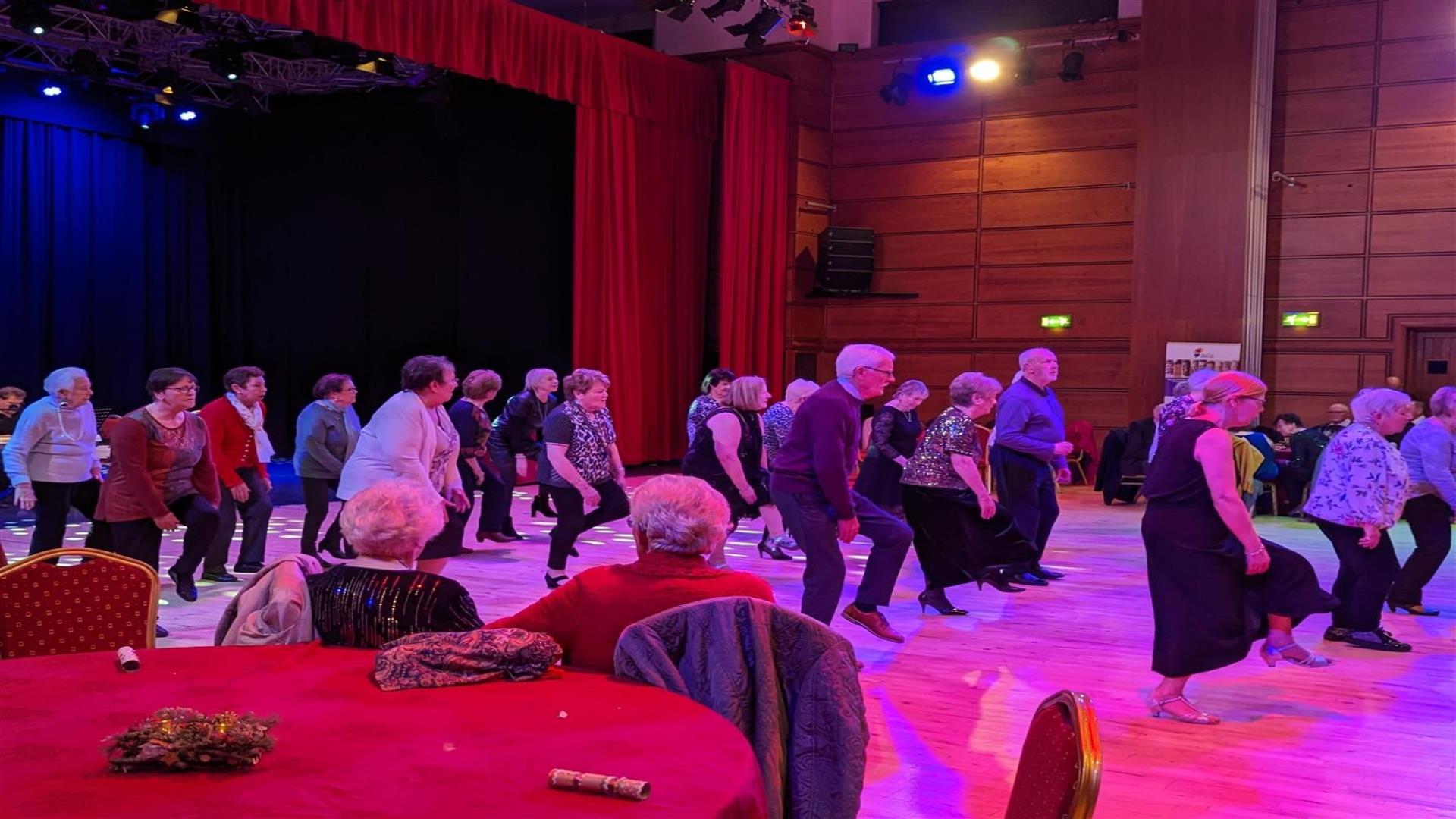 Image is of people dancing on a dance floor