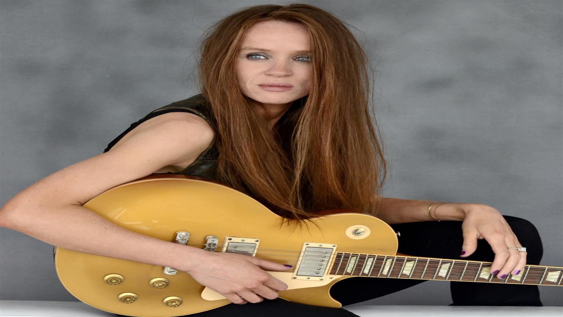 Image is of musician Grainne Duffy with her guitar
