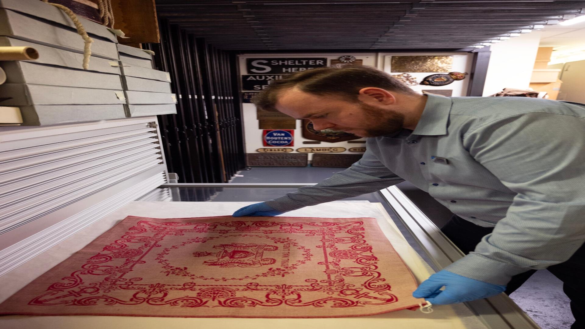 Image history curator examining an artefact