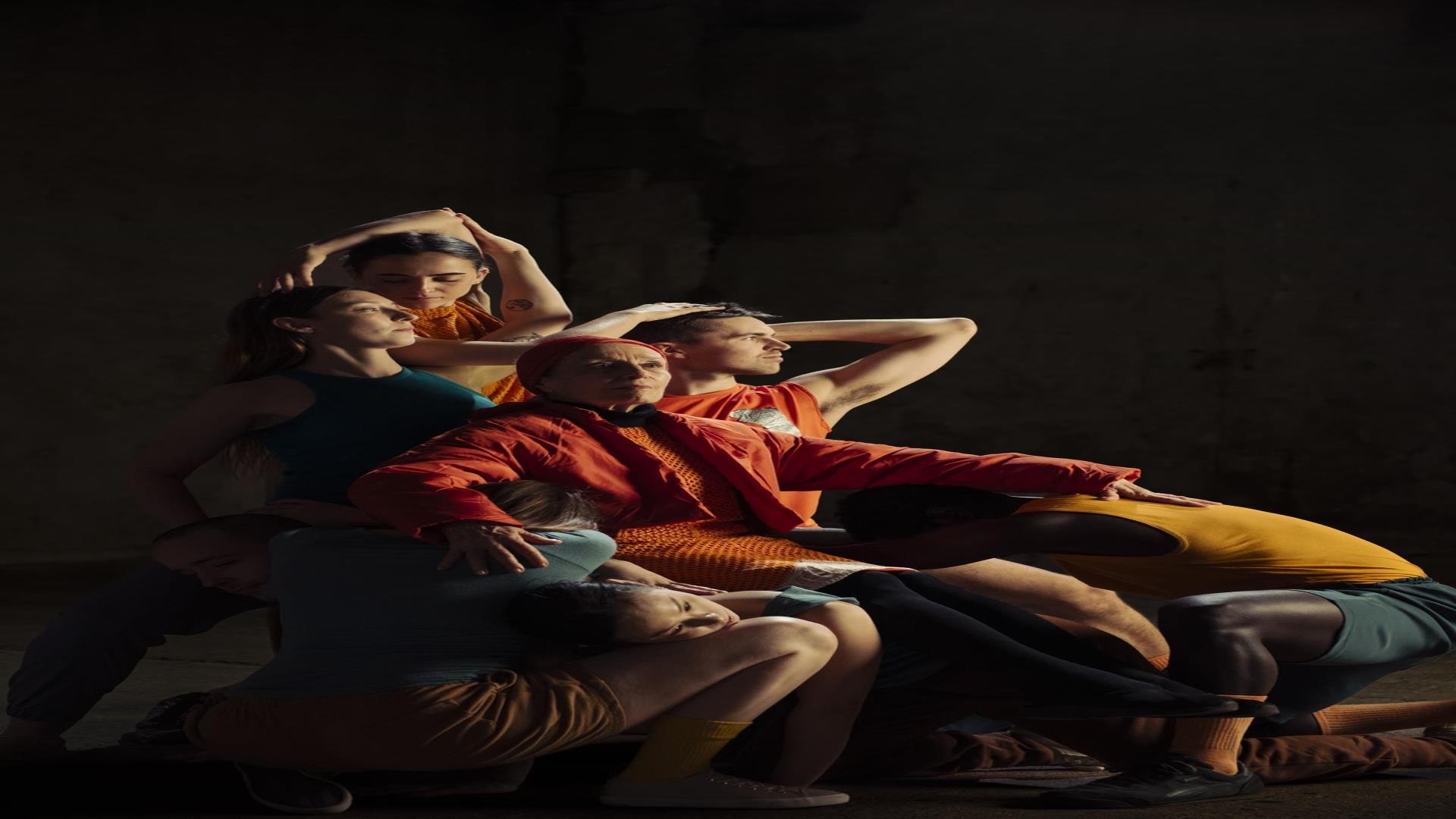 Image is of dancers on stage performing Trojans