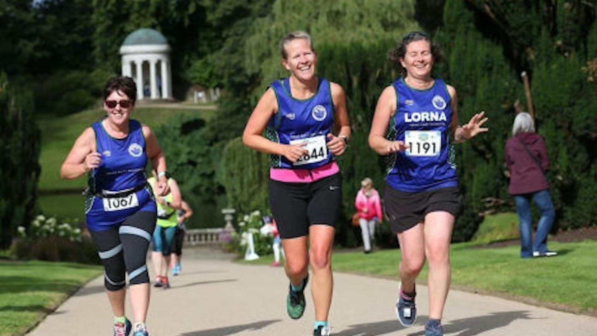 Image shows runners in Hillsborough Castle Gardens.