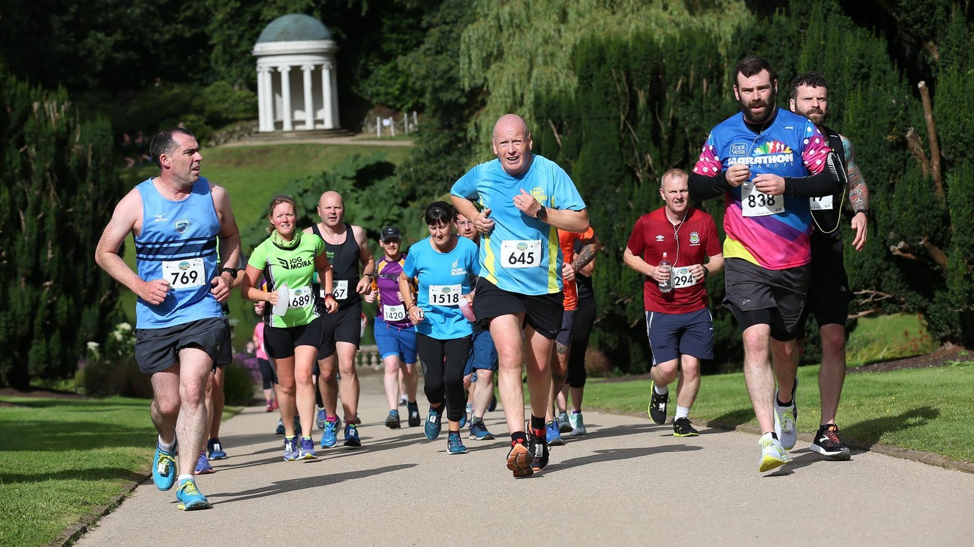 Runners running up the hill with Lady Alice's Temple in the background