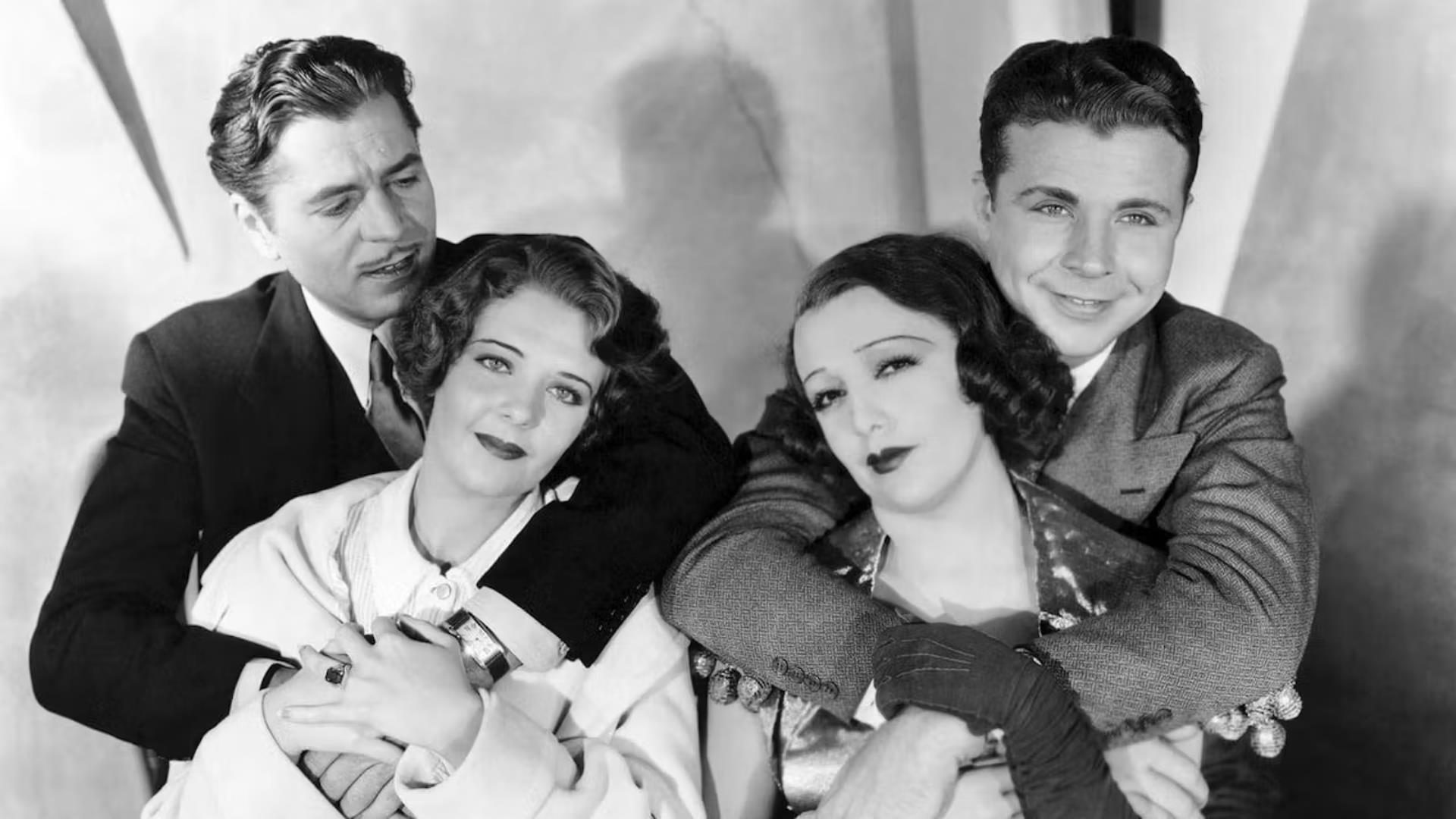 Black and white photo from movie 42nd Street 2 men hugging 2 women