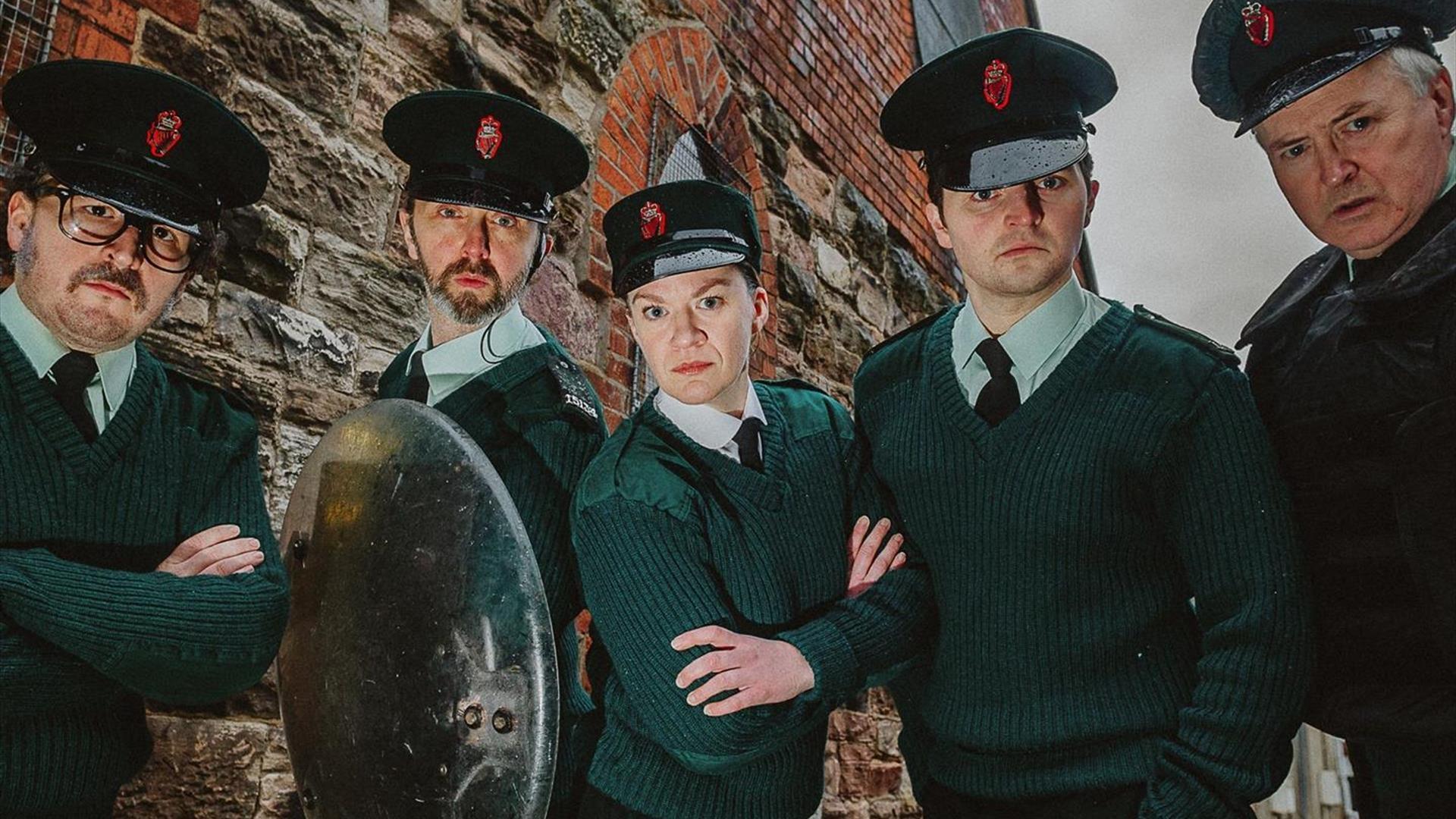 Image shows 4 people dressed in police uniform.