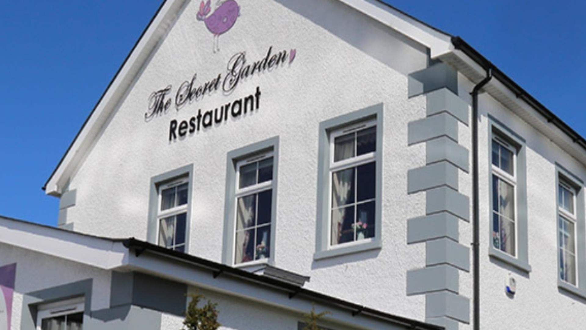 Image shows the outside of The Secret Gardens Restaurant.