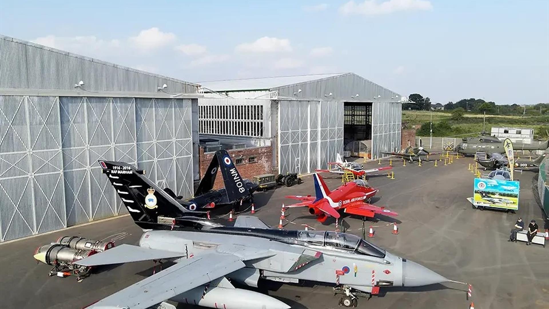 image is of various planes at the Ulster Aviation Society