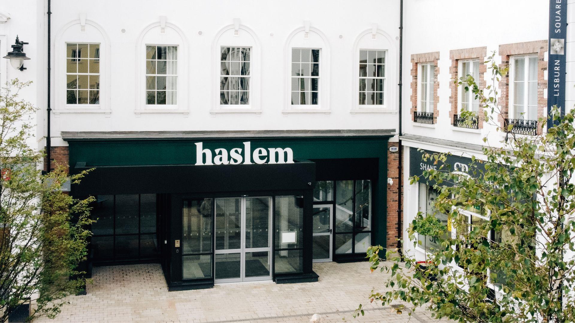 Shot of exterior of Haslem Hotel in corner Lisburn Square with trees to either side