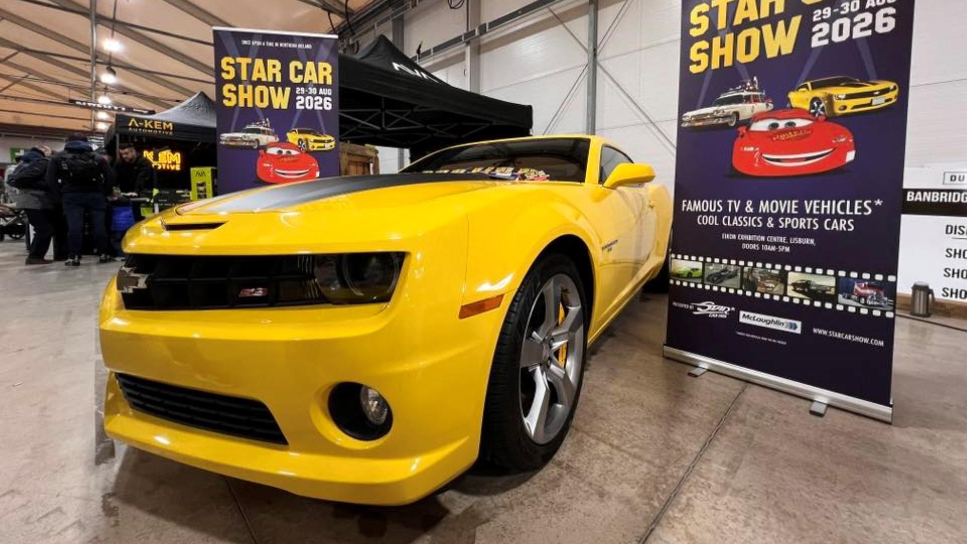 Yellow car parked in front of information stand