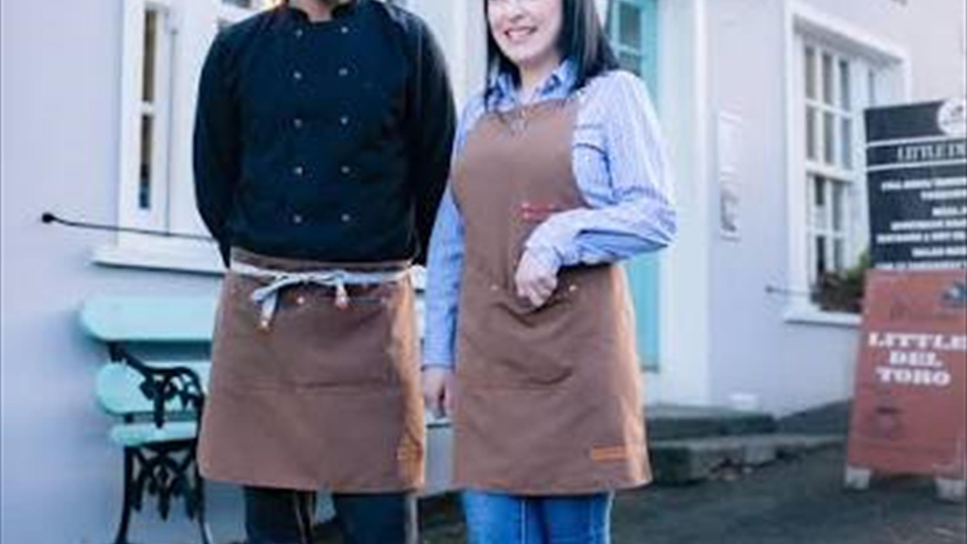 Owners standing outside resturant