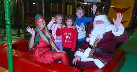 Picture of Children in soft play area beside Santa Claus and elf