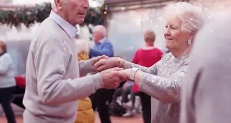 Picture of two people dancing together.