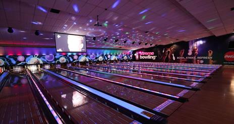 Picture of lit up bowling lanes.