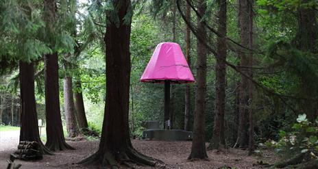 The Lamp sculpture through the trees in Hillsborough Forest Park