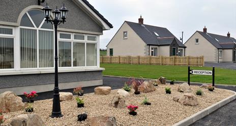 Image shows outside of property with signage pointing to Reception area