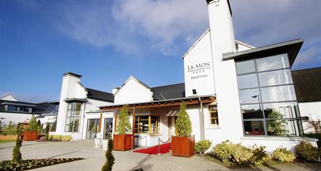 Image shows front of hotel and entrance