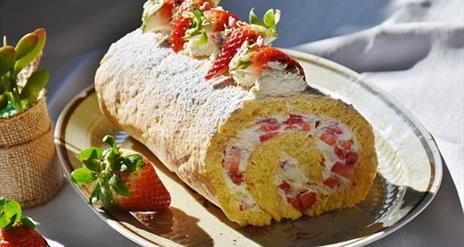 Image is of a strawberry and cake roll
