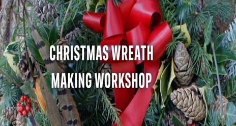 Image shows Christmas Wreath with red ribbon and berries.