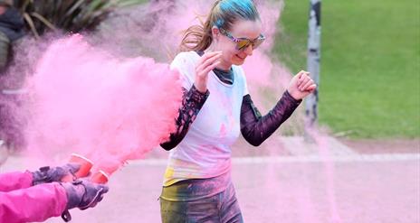 Picture of a running being being colour bombed
