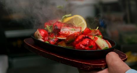 Image is of Indian food being served