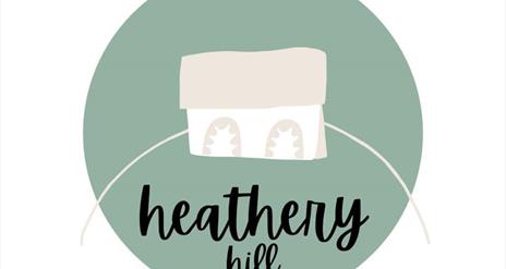 Images shows logo of heathery hill which is a small house within a green circle