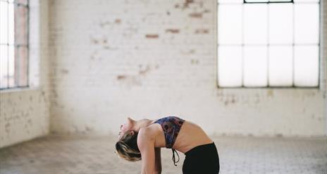 Lady doing yoga on pink mat