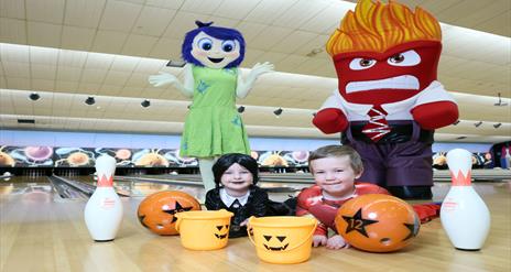 Image shows characters and two children in Halloween Costumes at Dundonald International Ice Bowl