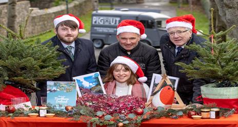 An image of Alderman Allan Ewart Chairman of the Development Committee & Councillor Aaron McIntyre Chairman of Leisure Services with traders at Royal