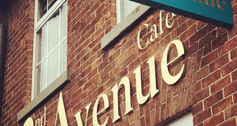 Image shows front of 2nd Avenue Cafe with named sign