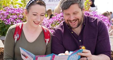 Couple reading the brochure for the show