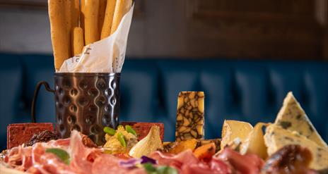 A platter of cheese and meats served at Hinch Brasserie