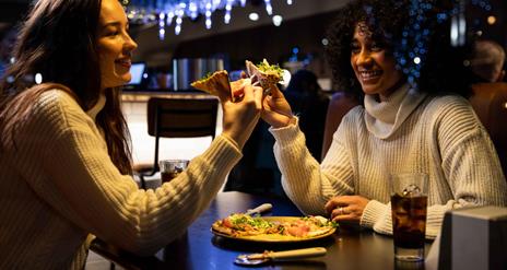 Two girls enjoying pizza at Little Wing's, Lisburn