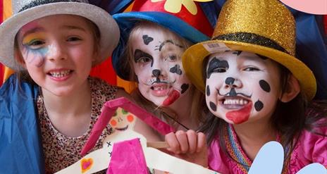 Three children dressed up in fancy dress and their faces are painted