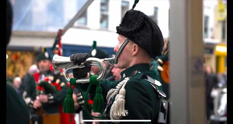 Image is of a bugler playing